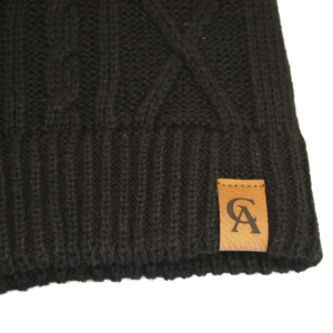 Classic cable-knit hat for warmth and style. Deep fit. Unlined. CA logo in subtle faux-leather detail. One size. Black. Manufactured by Ouray. 100% Acrylic Yarns.